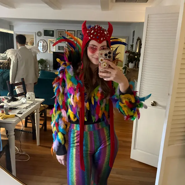 Customer wearing the red devil bonnet in a colorful costume